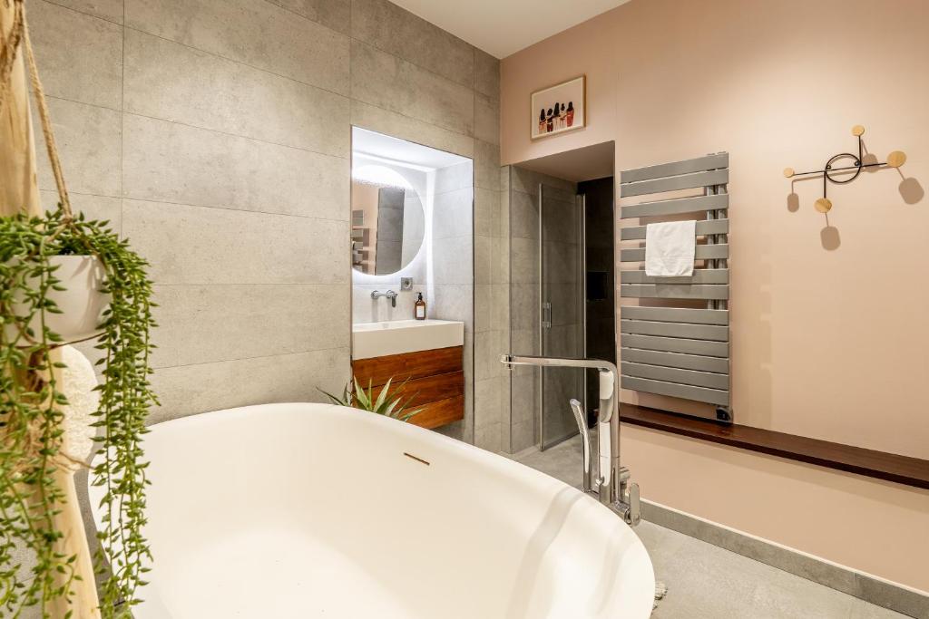 Main bathroom — freestanding tub, walk-in shower, heated towel rail